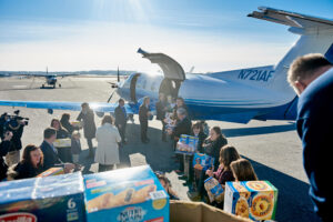 Loading a PlaneSense PC-12 with donations for NH Food Bank